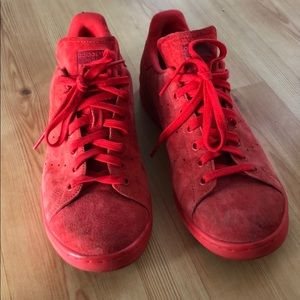 Red suede Adidas Stan Smith sneakers